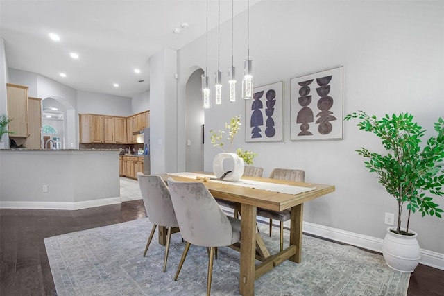 114 Mcbride Ln, Cedar Park, TX 78613 - dining room featuring arched walkways, baseboards, dark wood-style floors, and recessed lighting