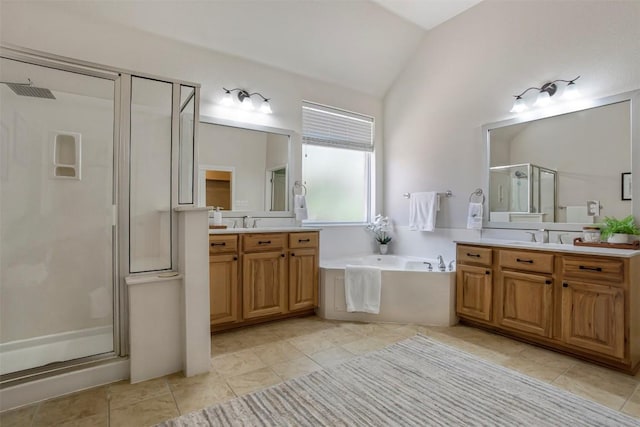 114 Mcbride Ln, Cedar Park, TX 78613 - bathroom with vaulted ceiling, a shower stall, two vanities, a bath, and tile patterned flooring