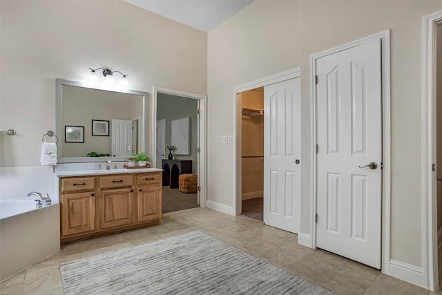 114 Mcbride Ln, Cedar Park, TX 78613 - bathroom featuring vanity, a garden tub, a walk in closet, and tile patterned flooring