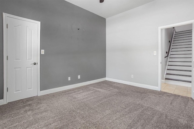 114 Mcbride Ln, Cedar Park, TX 78613 - empty room featuring light colored carpet, stairs, baseboards, a ceiling fan, and light tile patterned floors