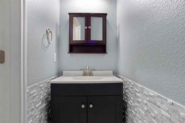 114 Mcbride Ln, Cedar Park, TX 78613 - bathroom with vanity, a wainscoted wall, and tile walls