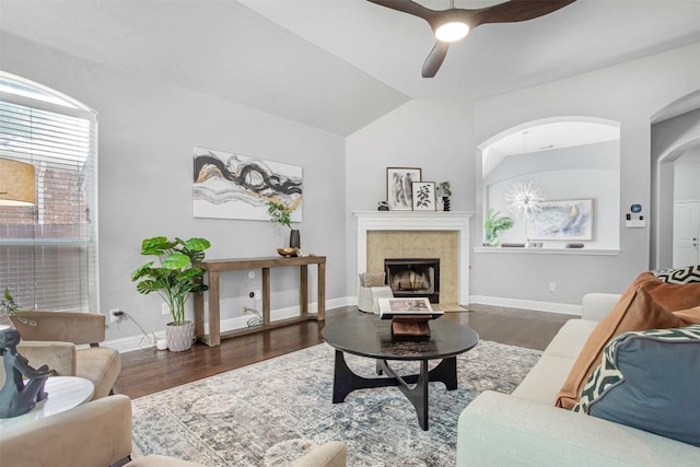 114 Mcbride Ln, Cedar Park, TX 78613 - living room featuring wood finished floors, vaulted ceiling, a ceiling fan, baseboards, and a tiled fireplace