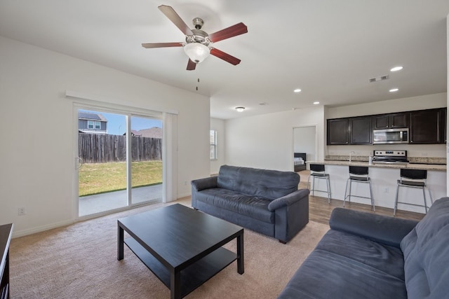 13804 Mark Christopher Way, Manor, TX 78653 - living room featuring light colored carpet, recessed lighting, a ceiling fan, and baseboards