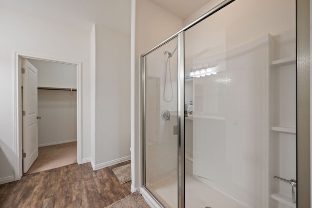 13804 Mark Christopher Way, Manor, TX 78653 - bathroom featuring a shower stall, wood finished floors, and a spacious closet