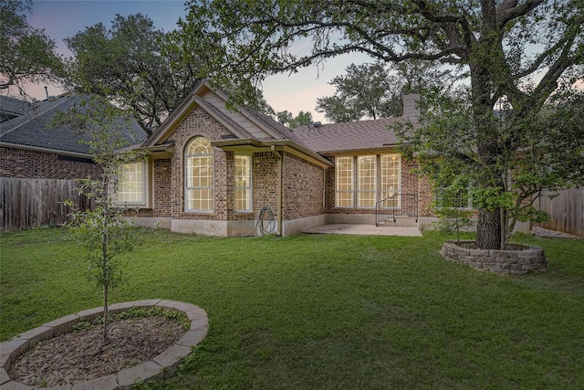 6411 Abilene Trl, Austin, TX 78749 - back of property featuring brick siding, a patio area, and a chimney