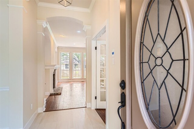 6411 Abilene Trl, Austin, TX 78749 - entryway with arched walkways, crown molding, and a high end fireplace