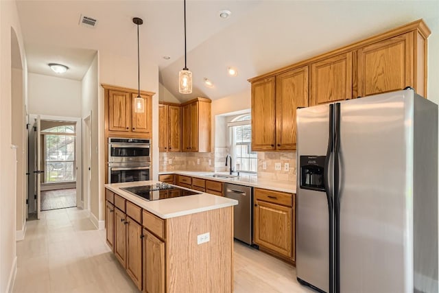 6411 Abilene Trl, Austin, TX 78749 - kitchen with stainless steel appliances, healthy amount of natural light, a center island, backsplash, and lofted ceiling