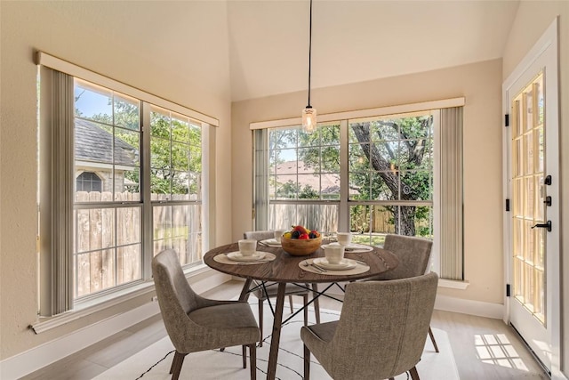6411 Abilene Trl, Austin, TX 78749 - dining space with baseboards, healthy amount of natural light, light wood-style flooring, and lofted ceiling
