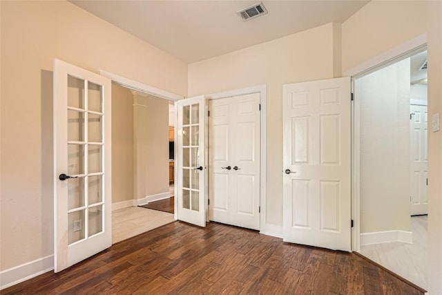 6411 Abilene Trl, Austin, TX 78749 - unfurnished bedroom with french doors, dark wood-style flooring, baseboards, and a closet