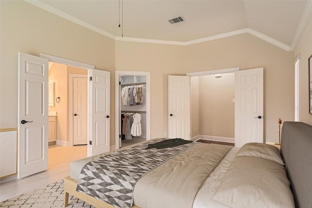 6411 Abilene Trl, Austin, TX 78749 - bedroom with light wood-style floors, crown molding, lofted ceiling, baseboards, and a closet