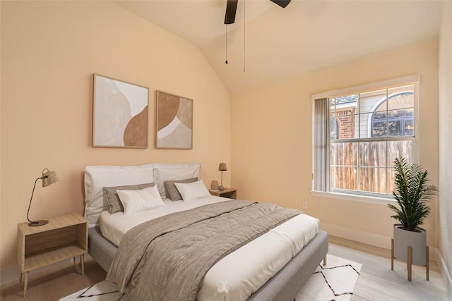 6411 Abilene Trl, Austin, TX 78749 - bedroom with light wood-type flooring, baseboards, vaulted ceiling, and a ceiling fan