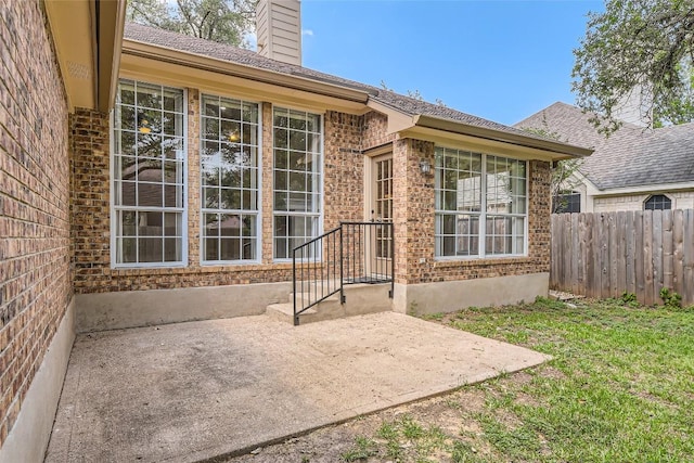 6411 Abilene Trl, Austin, TX 78749 - doorway to property with a chimney, brick siding, and a patio area