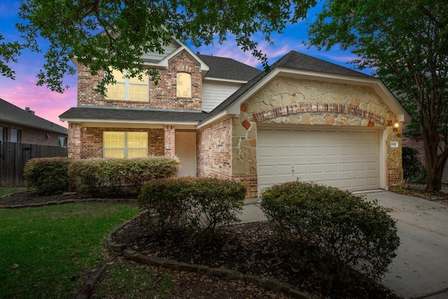 3505 Winding Shore Ln, Pflugerville, TX 78660 - traditional-style house with brick siding, concrete driveway, a garage, stone siding, and roof with shingles