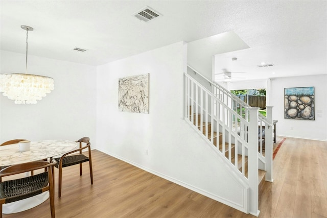 11208 Midbury Ct, Austin, TX 78748 - dining area with stairway, light wood-style floors, and a chandelier