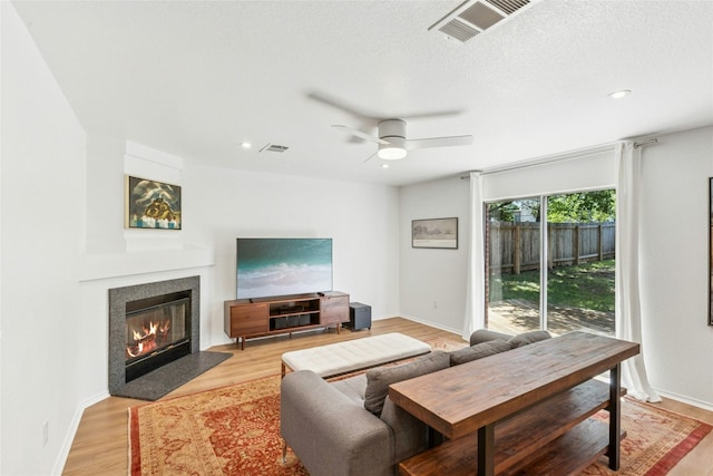 11208 Midbury Ct, Austin, TX 78748 - living room with ceiling fan, a fireplace with flush hearth, light wood finished floors, and recessed lighting