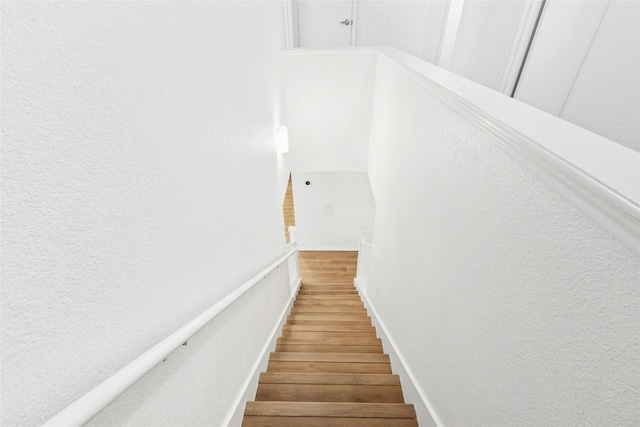 11208 Midbury Ct, Austin, TX 78748 - stairway featuring wood finished floors and a textured wall
