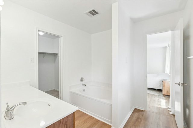 11208 Midbury Ct, Austin, TX 78748 - ensuite bathroom featuring a tub to relax in, wood finished floors, and vanity