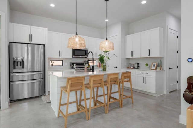 2935 Moss St Unit 1, Austin, TX 78722 - kitchen with appliances with stainless steel finishes, concrete flooring, decorative backsplash, recessed lighting, and light countertops