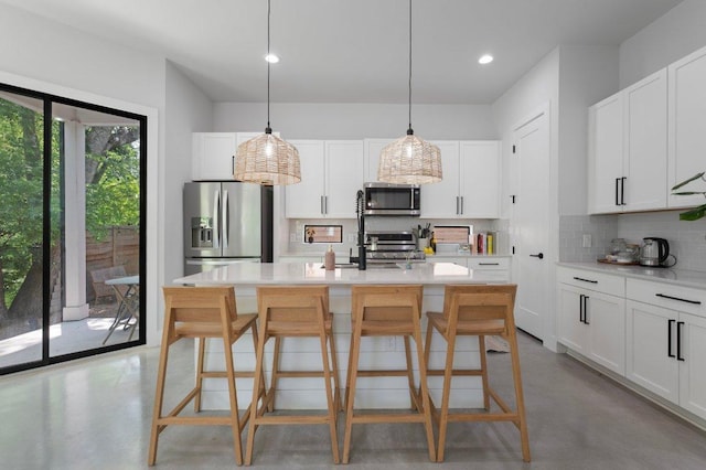 2935 Moss St Unit 1, Austin, TX 78722 - kitchen featuring appliances with stainless steel finishes, finished concrete floors, decorative backsplash, light countertops, and a breakfast bar
