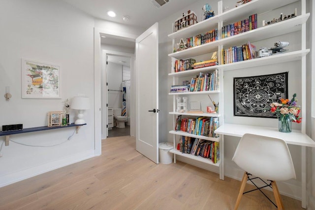 2935 Moss St Unit 1, Austin, TX 78722 - living area featuring wood finished floors, baseboards, and recessed lighting