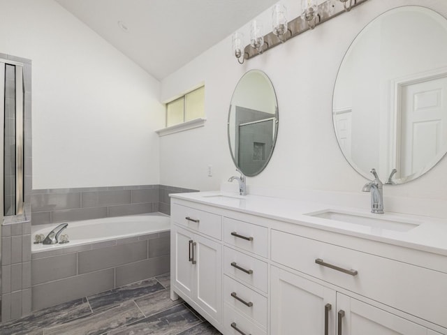 2424 Emmett Pkwy, Austin, TX 78728 - bathroom featuring double vanity, a bath, and lofted ceiling