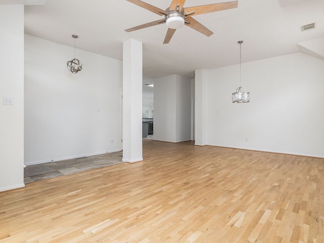2424 Emmett Pkwy, Austin, TX 78728 - unfurnished living room with a chandelier, light wood-style flooring, a ceiling fan, and baseboards