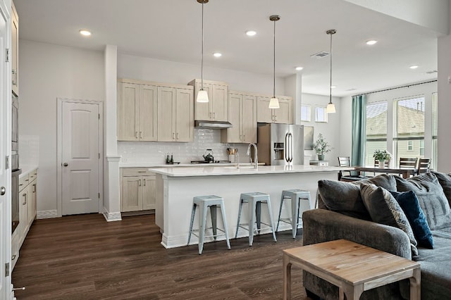 17720 Cain Clearing Pass, Austin, TX 78738 - kitchen with stainless steel fridge, dark wood-style floors, light countertops, decorative backsplash, and open floor plan
