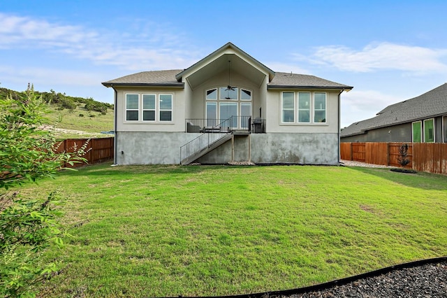 17720 Cain Clearing Pass, Austin, TX 78738 - back of property with a ceiling fan, a fenced backyard, stucco siding, and stairway