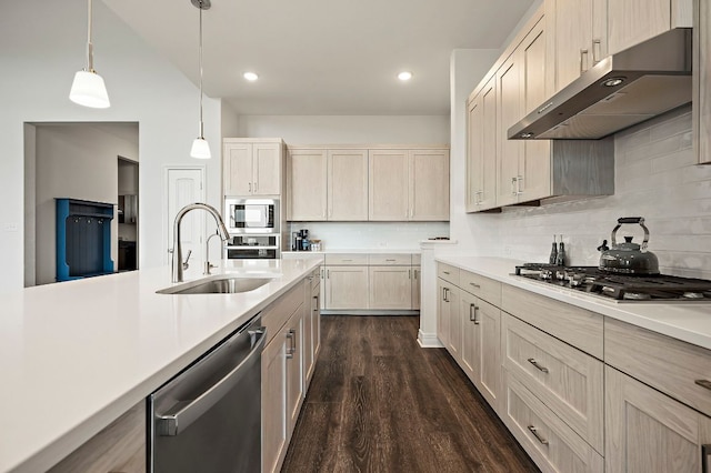 17720 Cain Clearing Pass, Austin, TX 78738 - kitchen featuring stainless steel appliances, under cabinet range hood, light countertops, dark wood-style floors, and recessed lighting