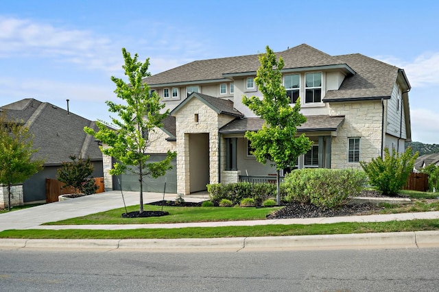 17720 Cain Clearing Pass, Austin, TX 78738 - view of front of home featuring stone siding, concrete driveway, covered porch, a shingled roof, and stucco siding
