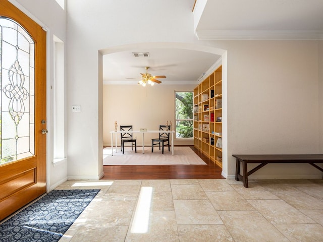 2009 Saint Andrews Dr, Round Rock, TX 78664 - entryway featuring crown molding, ceiling fan, and arched walkways