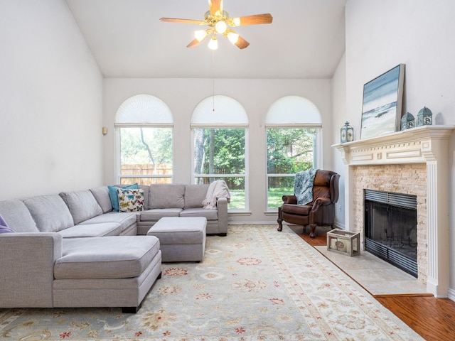 2009 Saint Andrews Dr, Round Rock, TX 78664 - living room with ceiling fan, lofted ceiling, a fireplace with flush hearth, and wood finished floors
