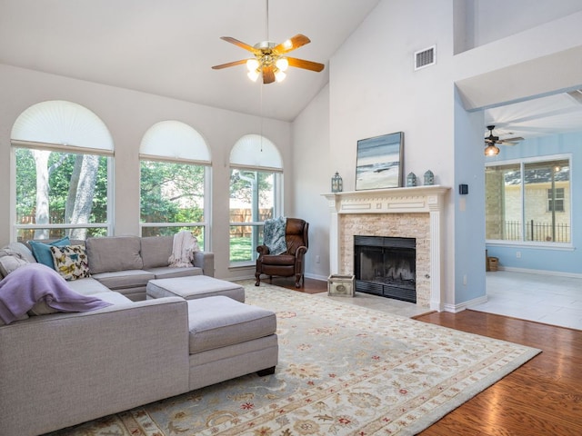 2009 Saint Andrews Dr, Round Rock, TX 78664 - living room with a ceiling fan, plenty of natural light, wood finished floors, high vaulted ceiling, and a stone fireplace