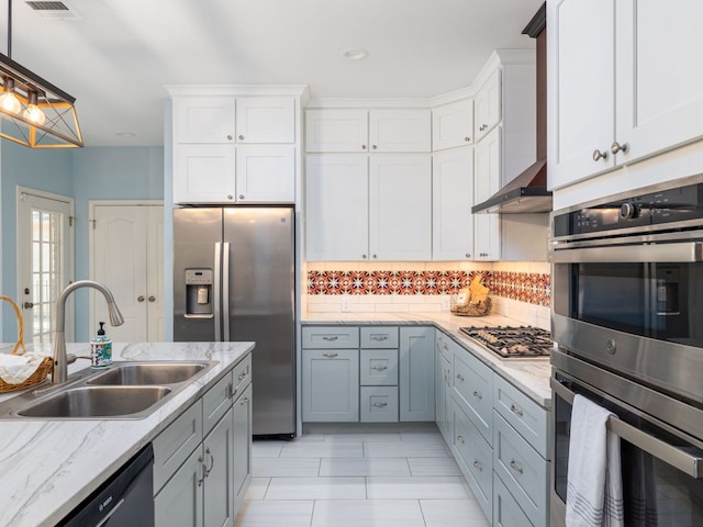 2009 Saint Andrews Dr, Round Rock, TX 78664 - kitchen featuring appliances with stainless steel finishes, decorative backsplash, white cabinetry, pendant lighting, and light stone countertops