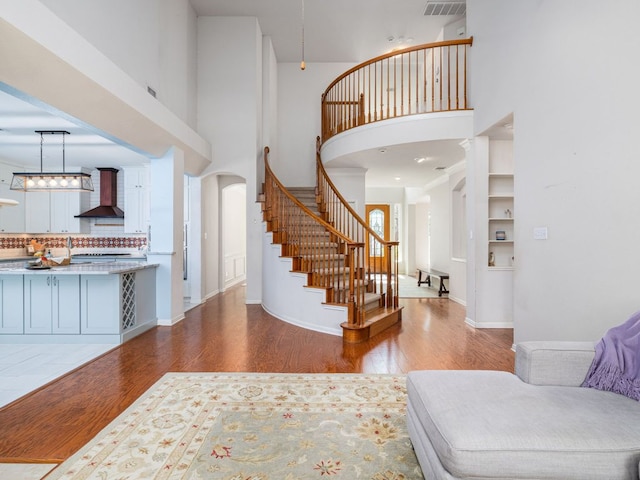 2009 Saint Andrews Dr, Round Rock, TX 78664 - entryway with stairs, wood finished floors, a towering ceiling, and arched walkways