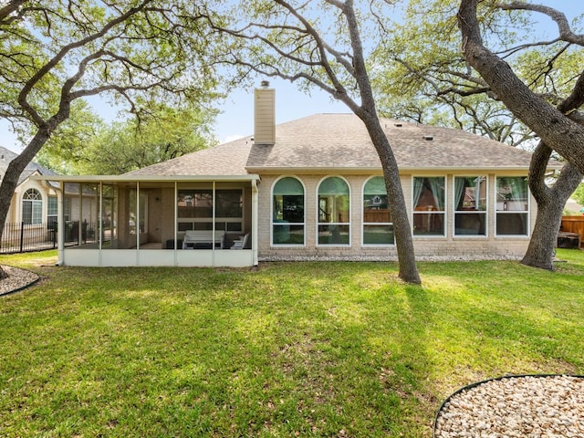 2009 Saint Andrews Dr, Round Rock, TX 78664 - back of house featuring a sunroom, a chimney, roof with shingles, and brick siding