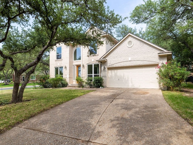 2009 Saint Andrews Dr, Round Rock, TX 78664 - traditional home with driveway, a garage, a front yard, and brick siding