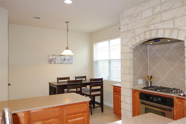 3707 Tall Cedars Rd, Cedar Park, TX 78613 - kitchen with stainless steel appliances, exhaust hood, light countertops, decorative backsplash, and hanging light fixtures
