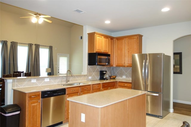 3707 Tall Cedars Rd, Cedar Park, TX 78613 - kitchen featuring stainless steel appliances, a ceiling fan, backsplash, a peninsula, and arched walkways