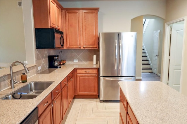 3707 Tall Cedars Rd, Cedar Park, TX 78613 - kitchen featuring stainless steel appliances, arched walkways, backsplash, and light stone countertops