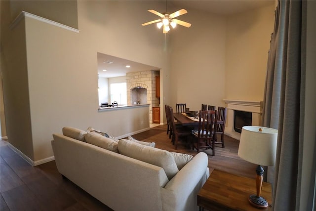 3707 Tall Cedars Rd, Cedar Park, TX 78613 - living room featuring a fireplace, ceiling fan, wood finished floors, and a high ceiling
