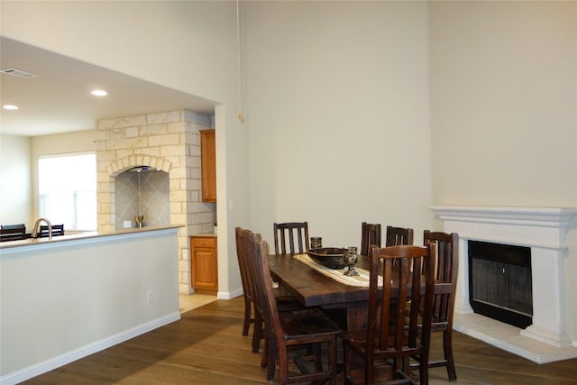 3707 Tall Cedars Rd, Cedar Park, TX 78613 - dining room featuring a glass covered fireplace, dark wood-style floors, and recessed lighting