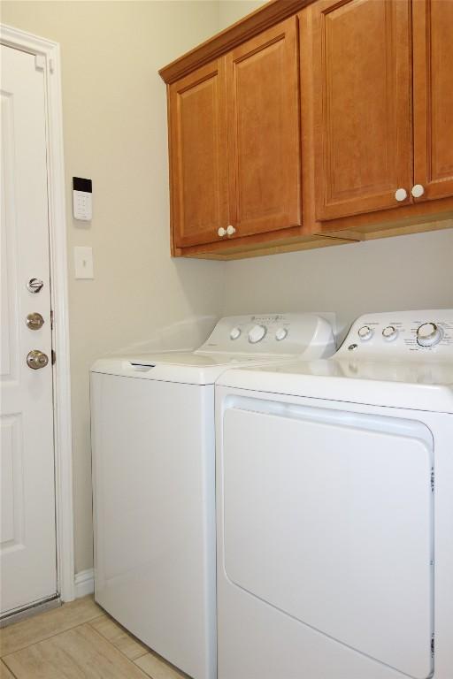 3707 Tall Cedars Rd, Cedar Park, TX 78613 - laundry room with separate washer and dryer, cabinet space, and light tile patterned floors