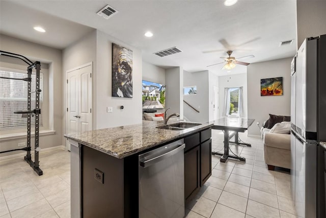 9502 Whisper Willow Blvd, Manor, TX 78653 - kitchen featuring stainless steel appliances, a sink, open floor plan, light tile patterned floors, and recessed lighting