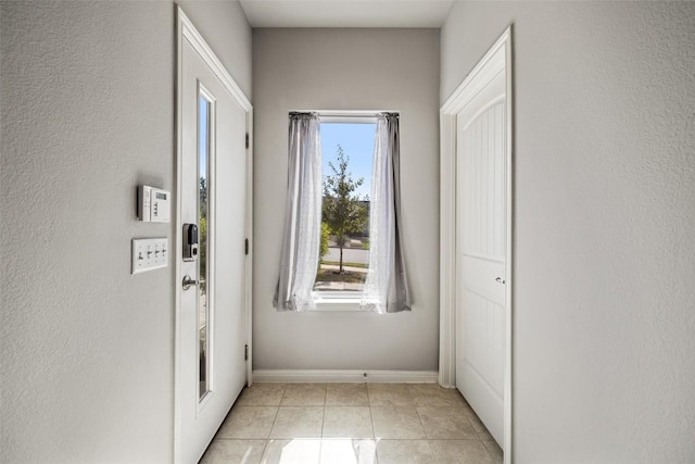 9502 Whisper Willow Blvd, Manor, TX 78653 - doorway featuring light tile patterned floors and baseboards