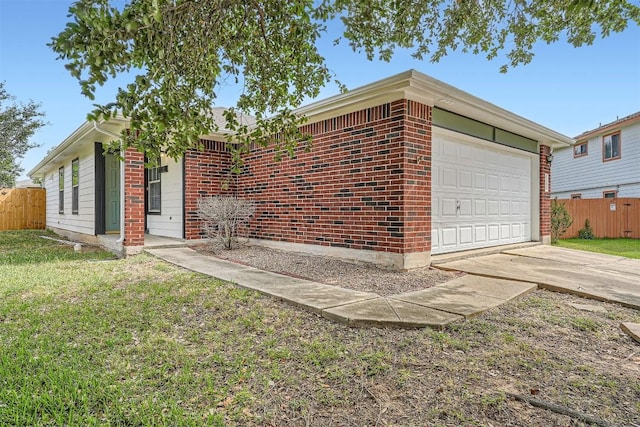 12404 Campana Dr, Del Valle, TX 78617 - view of front of property featuring an attached garage, concrete driveway, and brick siding