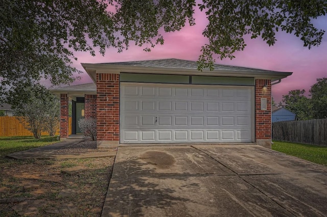 12404 Campana Dr, Del Valle, TX 78617 - view of front of home featuring driveway, brick siding, and a garage