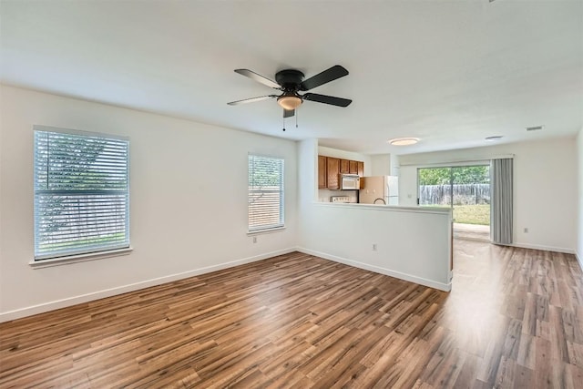 12404 Campana Dr, Del Valle, TX 78617 - unfurnished living room with light wood-type flooring and a ceiling fan