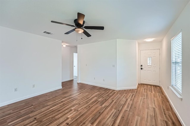 12404 Campana Dr, Del Valle, TX 78617 - spare room featuring wood finished floors, ceiling fan, and healthy amount of natural light