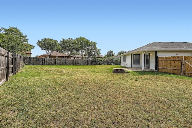 12404 Campana Dr, Del Valle, TX 78617 - fenced backyard with a patio area
